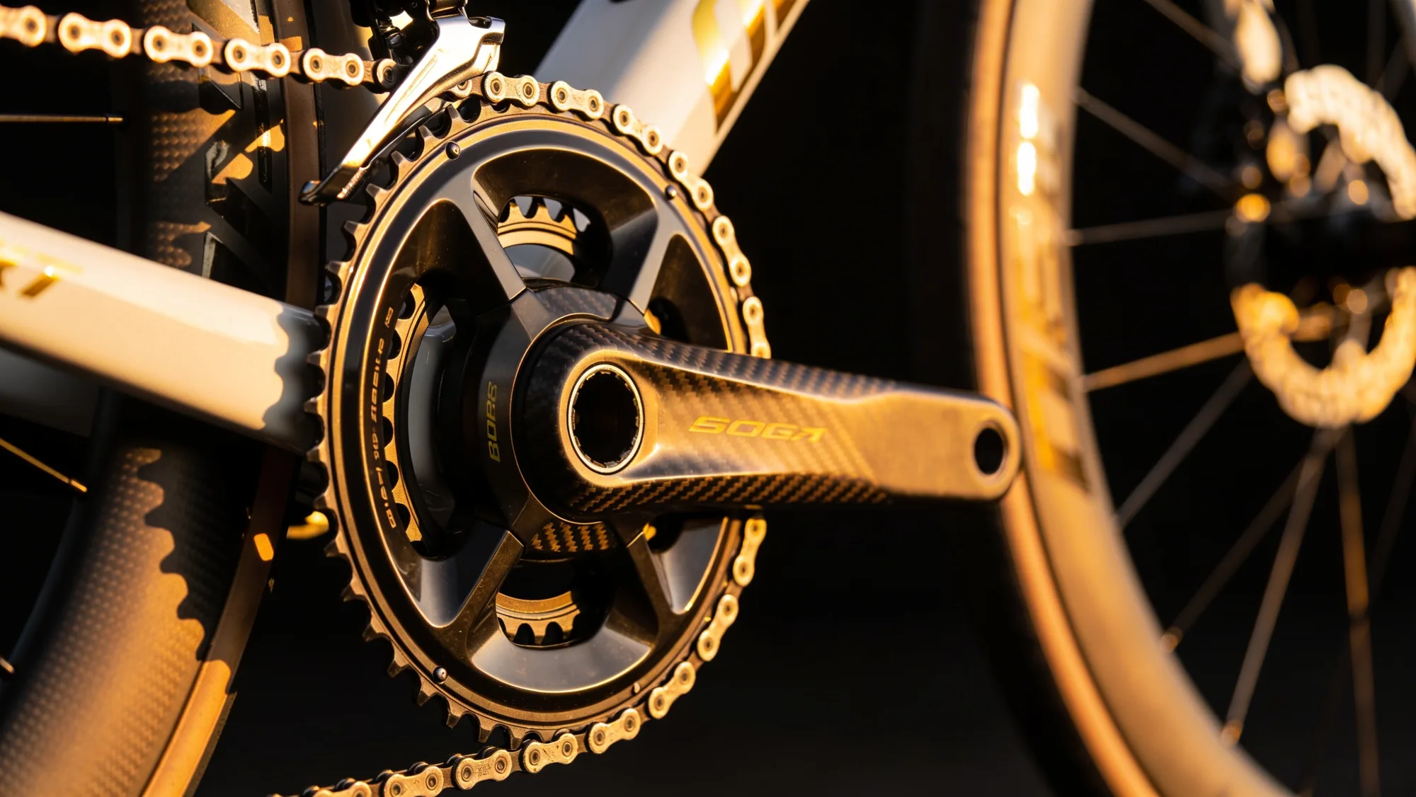 Carbon crankset and drivetrain detail at golden hour
